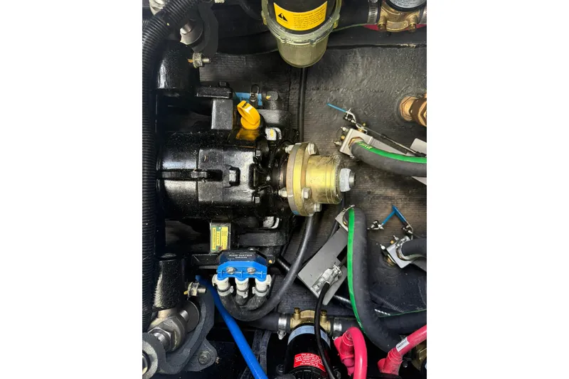 Slide: The Image of Engine components of 2024 Nautique Super Air Nautique S23 boat, featuring hoses and connectors. - 9