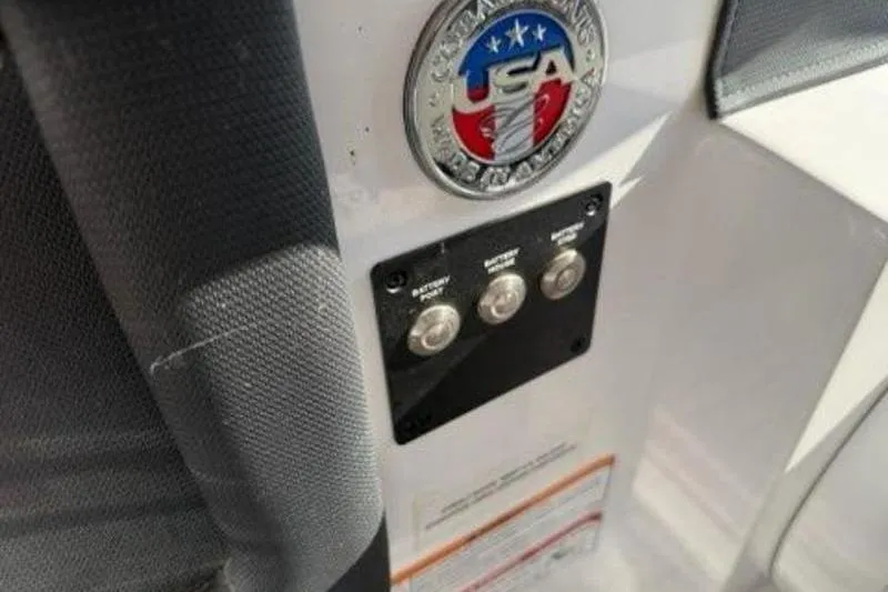 Slide: The Image of 2024 Cobalt R30 boat dashboard with USA emblem and control buttons. - 10