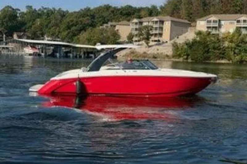 Slide: The Image of 2024 Cobalt R30 boat in vibrant red on a serene lake. - 4
