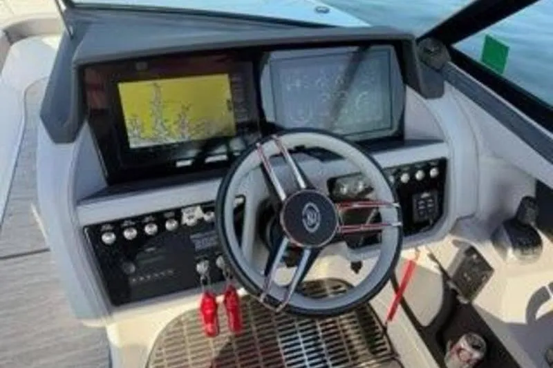 Slide: The Image of 2024 Cobalt R30 boat dashboard with steering wheel and navigation screens. - 5
