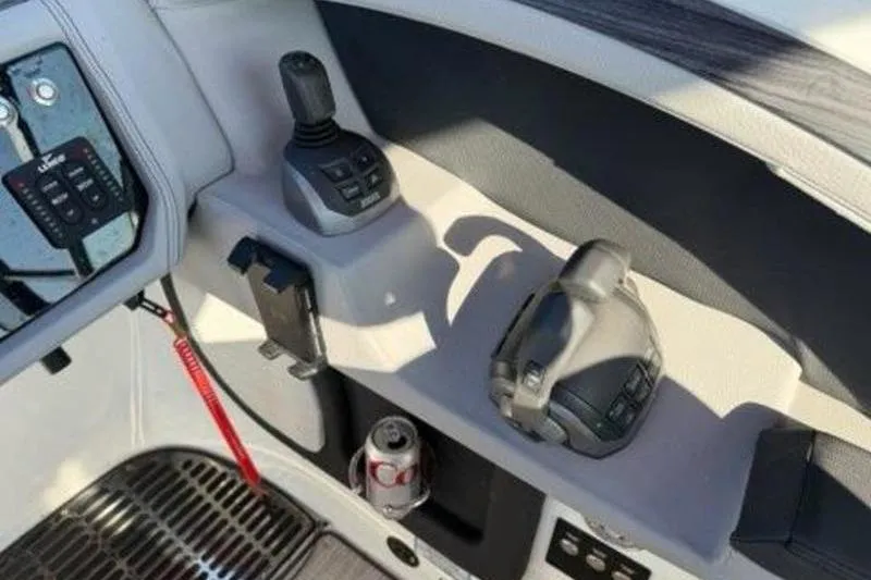 Slide: The Image of 2024 Cobalt R30 boat controls with joystick, throttle, and drink holder. - 8