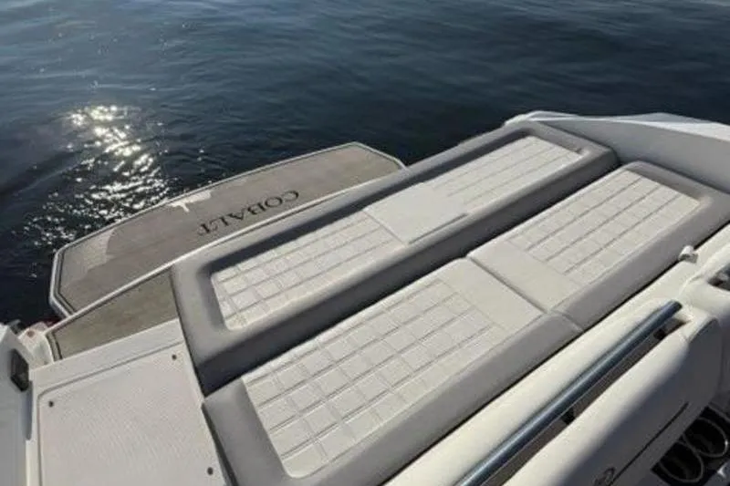 Slide: The Image of 2024 Cobalt R30 boat with sun pad and swim platform on calm water. - 9