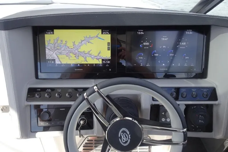 Slide: The Image of 2026 Cobalt A29 boat dashboard with dual Garmin displays and steering wheel. - 13