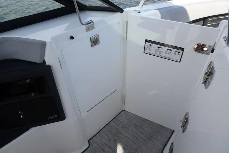 Slide: The Image of 2026 Cobalt A29 boat interior with open storage compartment and safety instructions. - 18
