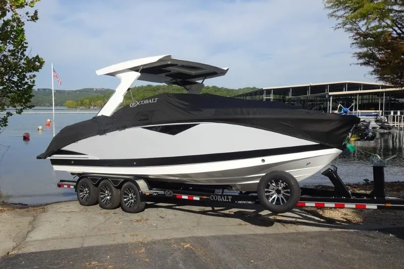 Slide: The Image of 2026 Cobalt A29 boat on trailer by lakeside, covered and ready for transport. - 29