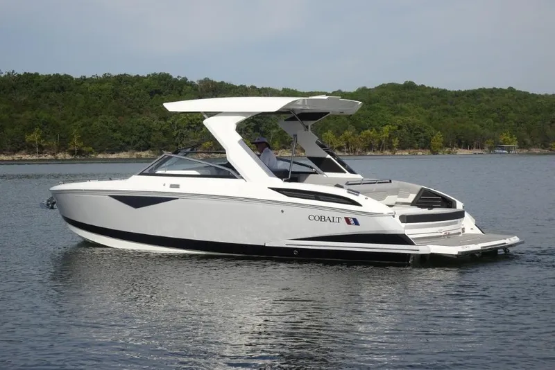 Slide: The Image of 2026 Cobalt A29 boat on a serene lake with lush green shoreline. - 3