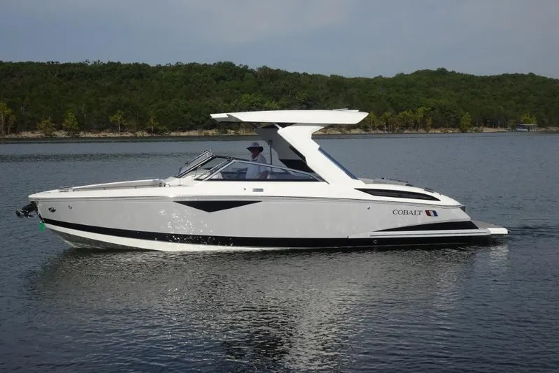 Slide: The Image of 2026 Cobalt A29 boat cruising on a serene lake with forested shoreline. - 4