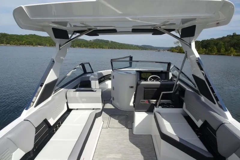Slide: The Image of 2026 Cobalt A29 boat interior with sleek seating and modern design on a serene lake. - 8