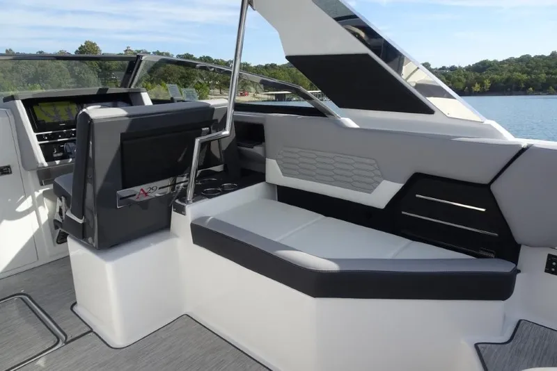Slide: The Image of 2026 Cobalt A29 boat interior with modern seating and dashboard, set against a scenic lake backdrop. - 9