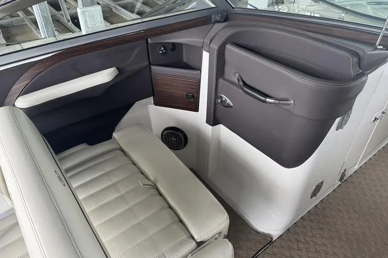 Slide: The Image of Interior of a 2015 Cobalt R7 boat with white cushioned seating. - 10