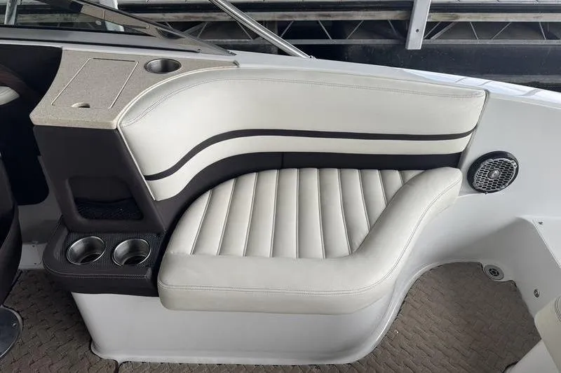 Slide: The Image of 2015 Cobalt R7 boat storage compartment with open door, featuring carpeted interior. - 12