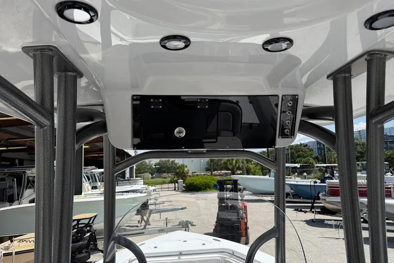 Slide: The Image of 2026 Sea Pro 222 Center Console boat interior with modern dashboard and overhead lighting. - 22
