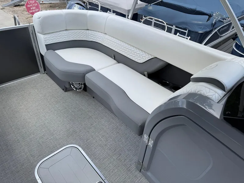 Slide: The Image of 2023 Godfrey Monaco 255 SD boat interior with gray and white seating. - 11