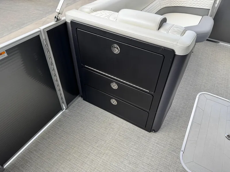 Slide: The Image of 2023 Godfrey Monaco 255 SD boat interior with storage drawers and seating. - 13