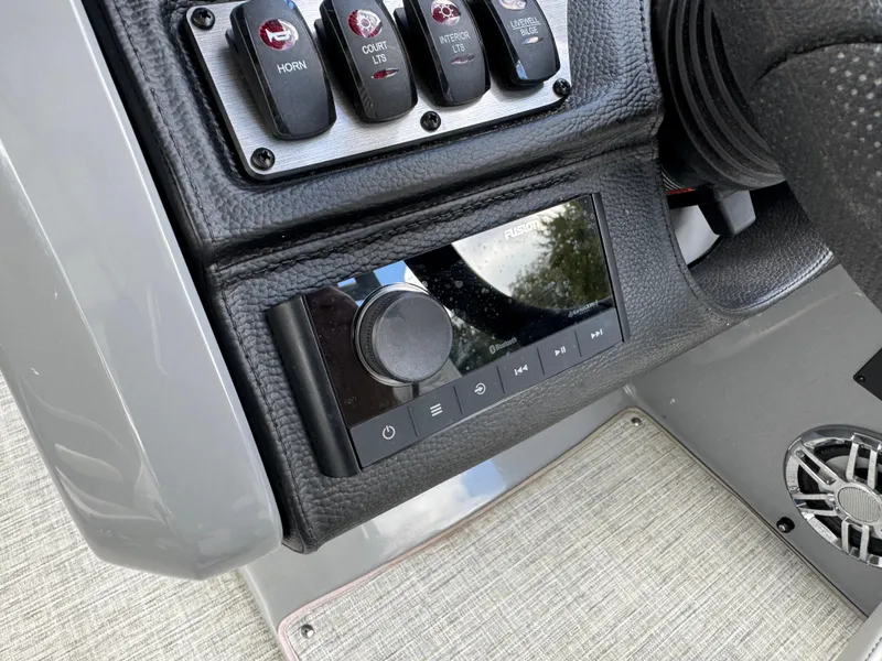 Slide: The Image of Control panel of 2023 Godfrey Monaco 255 SD boat with switches and audio system. - 27