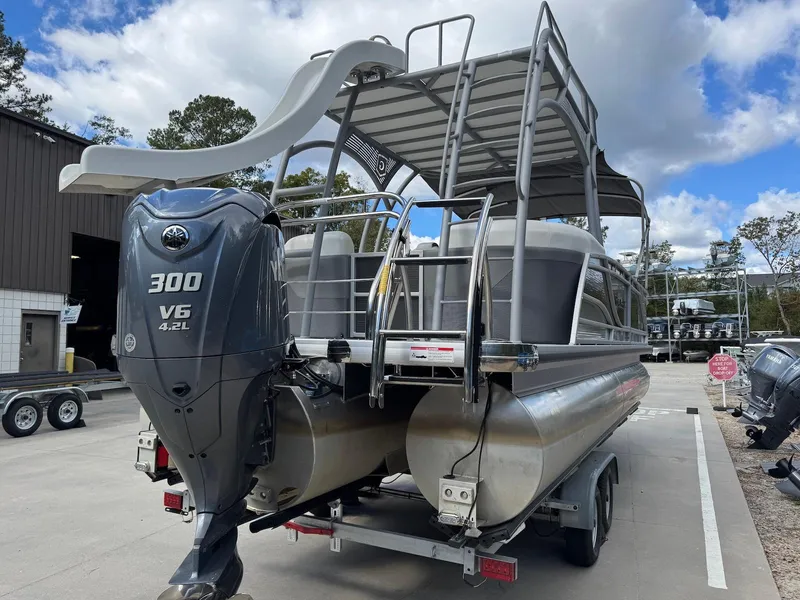 Slide: The Image of 2023 Godfrey Monaco 255 SD pontoon boat with Yamaha 300 V6 engine, parked outdoors. - 5