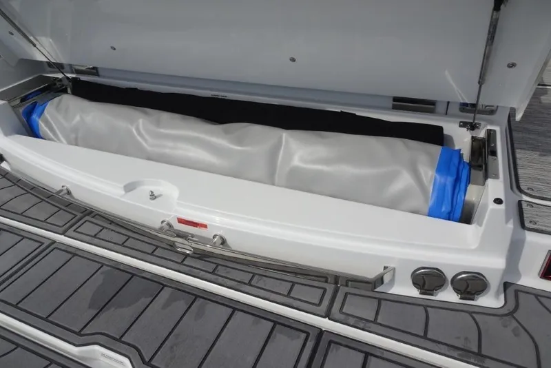 Slide: The Image of 2026 Cobalt A29 boat storage compartment with neatly packed inflatable item. - 11