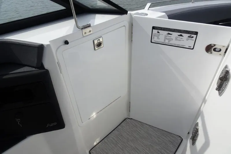 Slide: The Image of 2026 Cobalt A29 boat interior with storage compartment and safety instructions. - 22