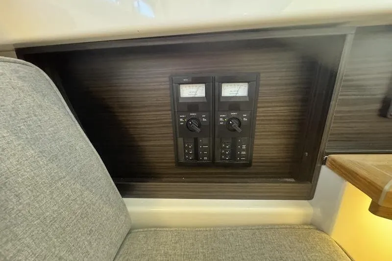 Slide: The Image of 2024 Cobalt R35 control panel with dual gauges and switches, set in a wooden interior. - 15