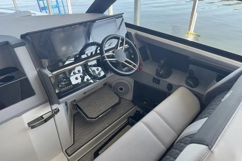 Slide: The Image of 2024 Cobalt R35 boat cockpit with modern steering and control panel. - 23