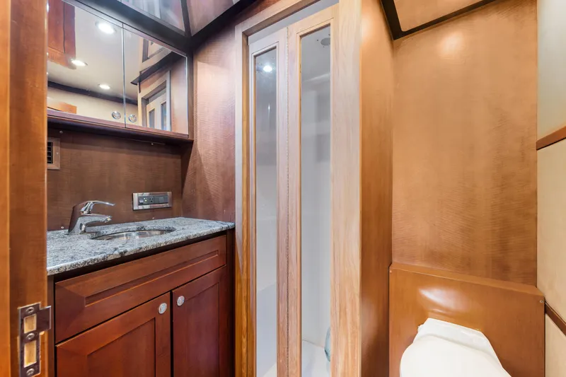 Slide: The Image of Luxurious bathroom in 2012 Bertram Custom Sportfish yacht with wood cabinetry and granite countertop. - 12