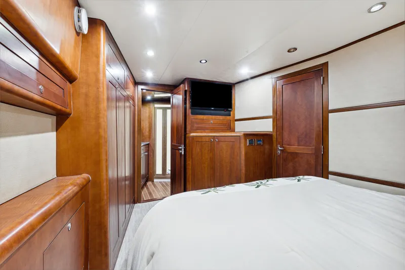 Slide: The Image of Luxurious cabin interior of 2012 Bertram Custom Sportfish yacht with wood paneling and modern amenities. - 14