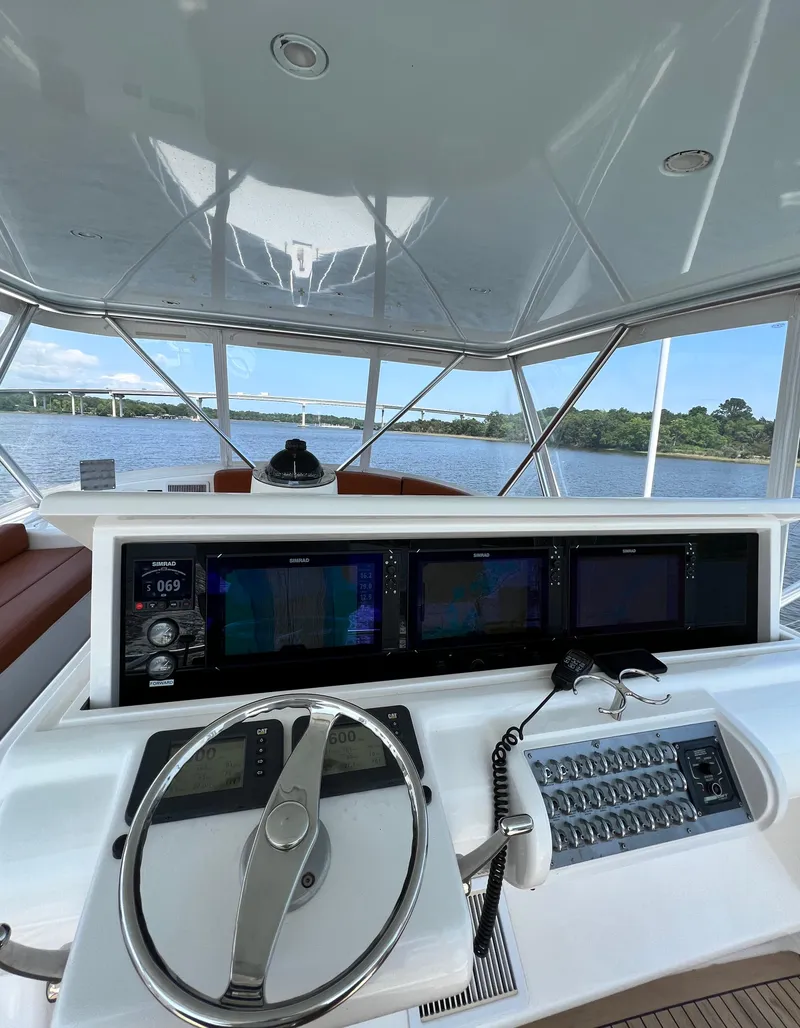 Slide: The Image of 2012 Bertram Custom Sportfish helm with advanced navigation systems on open water. - 16