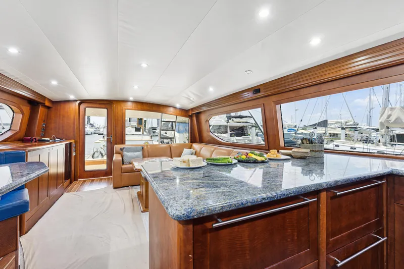 Slide: The Image of Luxurious interior of 2012 Bertram Custom Sportfish yacht with elegant wood finishes and spacious seating. - 7