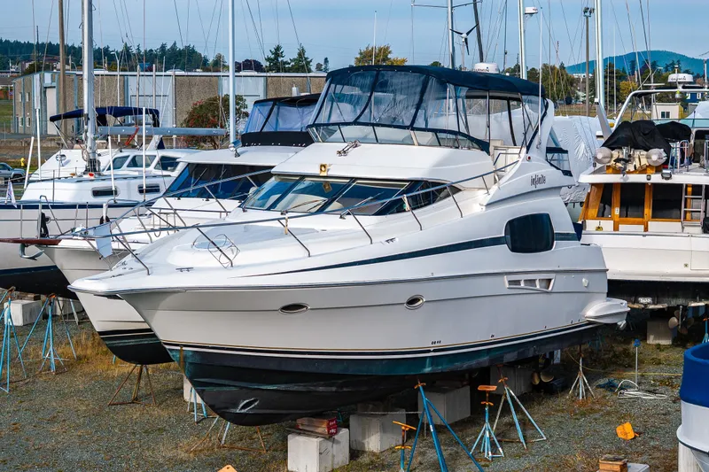 The Image of 2001 Silverton 410 Sport Bridge yacht on dry dock, surrounded by other boats. - 0