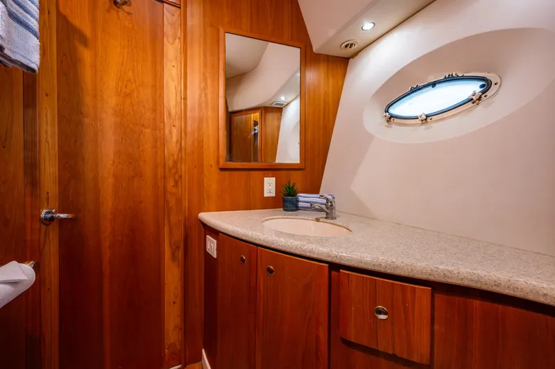 Slide: The Image of Luxurious bathroom interior of 2001 Silverton 410 Sport Bridge yacht with wooden cabinetry. - 11