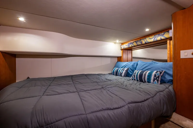 Slide: The Image of Cozy bedroom interior of 2001 Silverton 410 Sport Bridge yacht with modern bedding. - 12