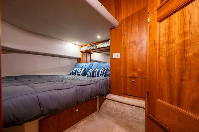 Slide: The Image of Luxurious cabin interior of 2001 Silverton 410 Sport Bridge yacht with cozy bedding. - 13