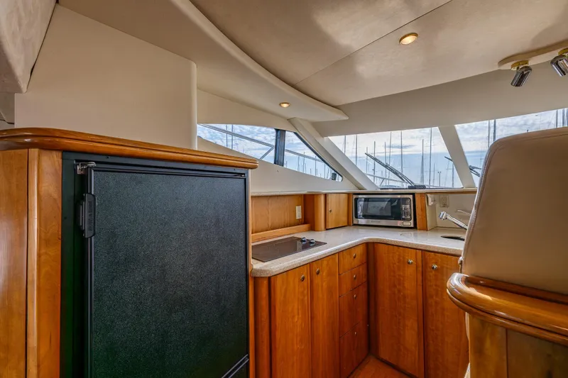 Slide: The Image of Interior of 2001 Silverton 410 Sport Bridge yacht with kitchenette and modern amenities. - 14