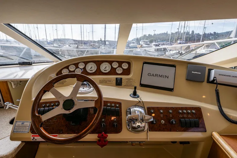 Slide: The Image of 2001 Silverton 410 Sport Bridge helm with Garmin navigation and wood-accented steering wheel. - 16