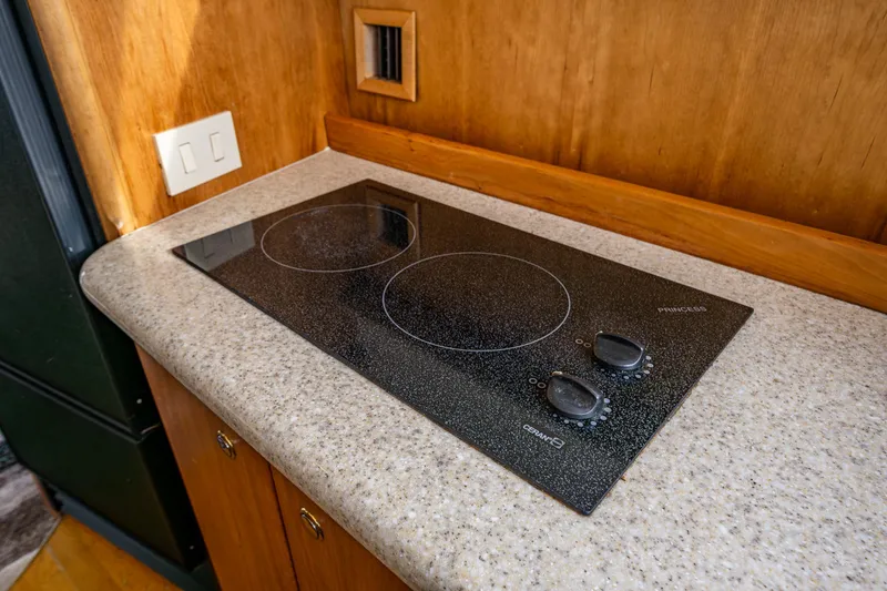 Slide: The Image of 2001 Silverton 410 Sport Bridge kitchen with electric stovetop on speckled countertop. - 18