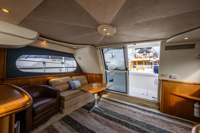 Slide: The Image of Interior of 2001 Silverton 410 Sport Bridge yacht with cozy seating and table. - 19