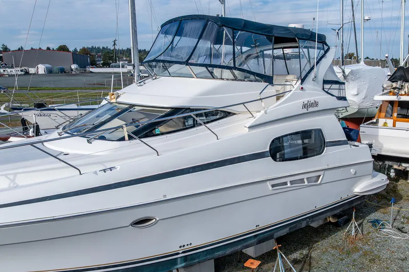 Slide: The Image of 2001 Silverton 410 Sport Bridge yacht docked, featuring sleek design and spacious upper deck. - 2