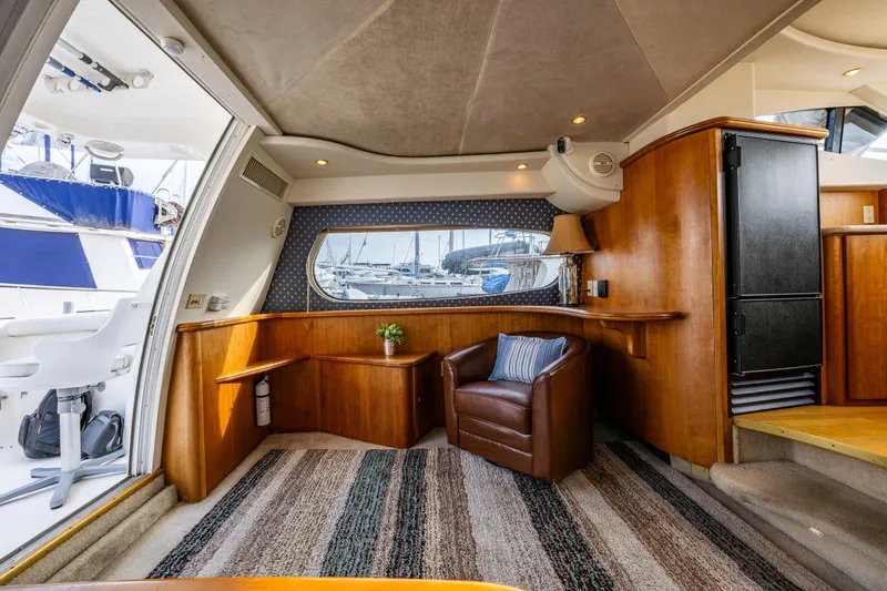 Slide: The Image of Interior of 2001 Silverton 410 Sport Bridge yacht with leather chair and nautical decor. - 21