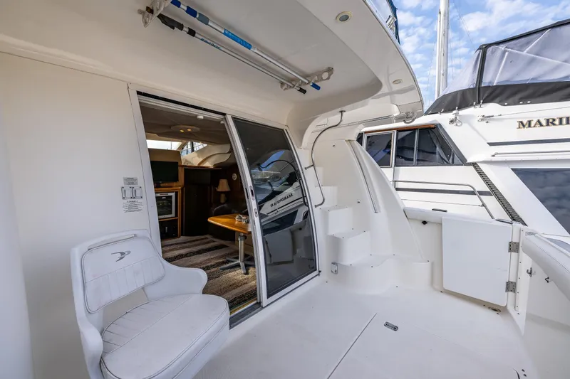 Slide: The Image of 2001 Silverton 410 Sport Bridge yacht interior with seating and sliding door. - 23