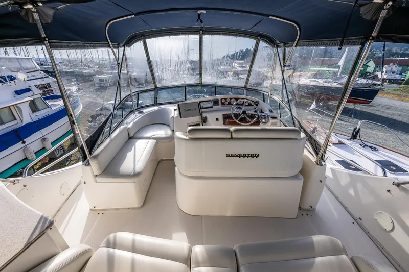 Slide: The Image of 2001 Silverton 410 Sport Bridge yacht interior with helm and seating area. - 27