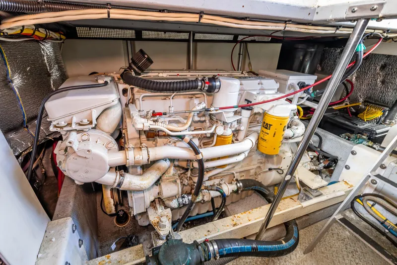 Slide: The Image of Engine room of a 2001 Silverton 410 Sport Bridge yacht, showcasing detailed machinery. - 33