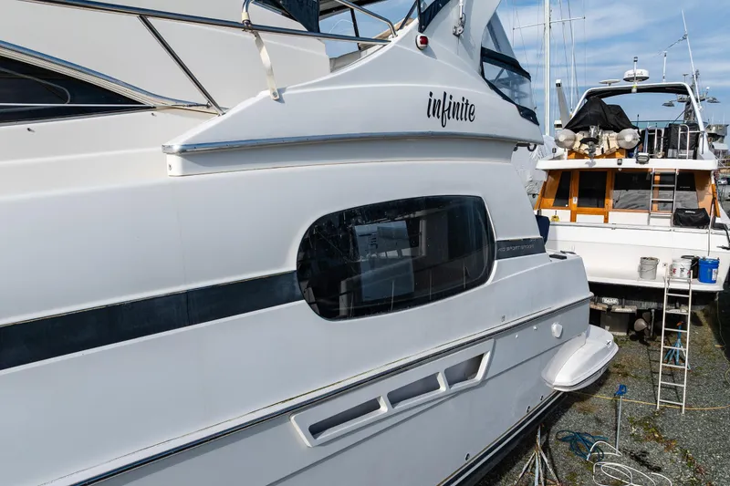 Slide: The Image of 2001 Silverton 410 Sport Bridge yacht docked, featuring sleek design and modern amenities. - 6