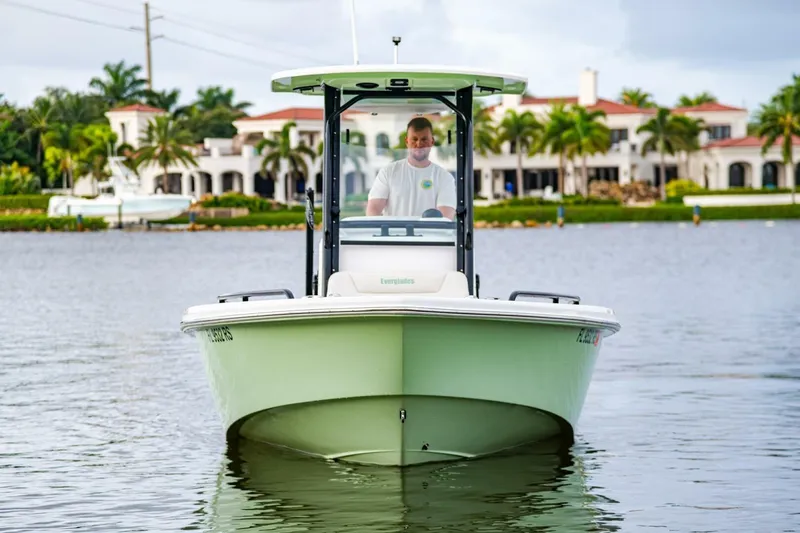Slide: The Image of 2018 Everglades 243 Center Console boat on water, with waterfront homes in background. - 11
