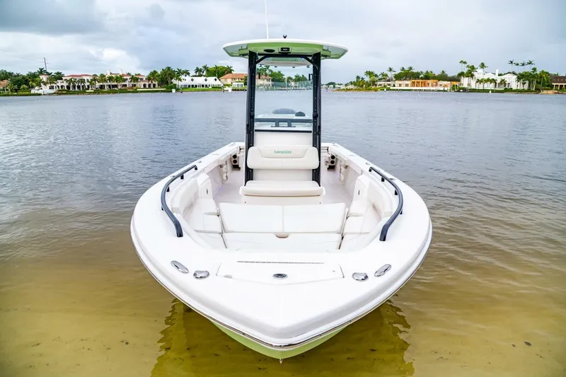 Slide: The Image of 2018 Everglades 243 Center Console boat on calm water, showcasing sleek design. - 12
