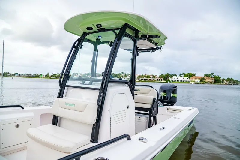 Slide: The Image of 2018 Everglades 243 Center Console boat on calm water, featuring a Yamaha 300 engine. - 18