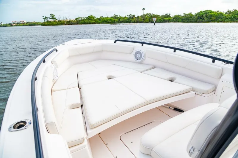 Slide: The Image of 2018 Everglades 243 Center Console boat with spacious seating on calm water. - 19
