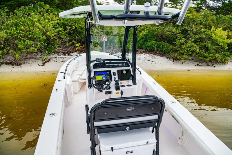 Slide: The Image of 2018 Everglades 243 Center Console boat docked on a sandy beach. - 25
