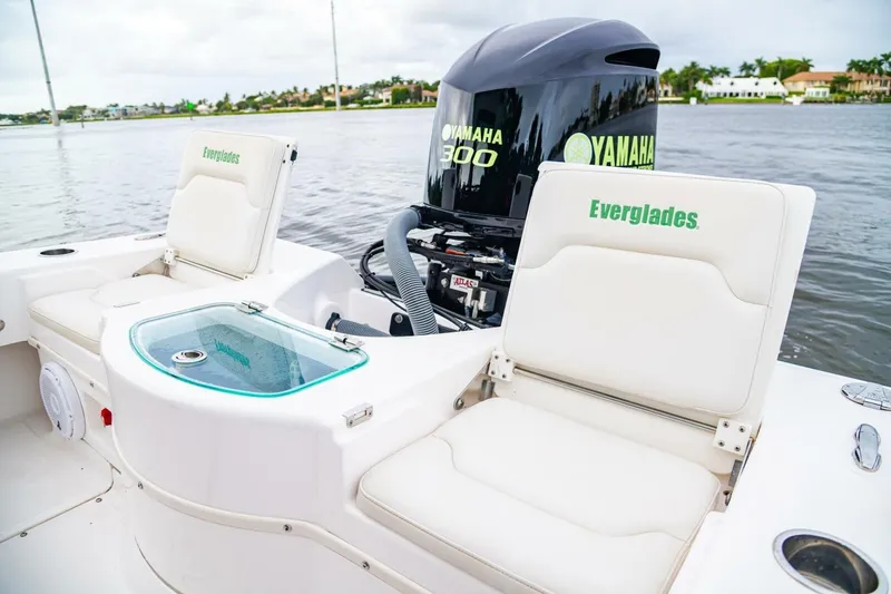 Slide: The Image of 2018 Everglades 243 Center Console boat with Yamaha 300 engine on a calm waterway. - 26