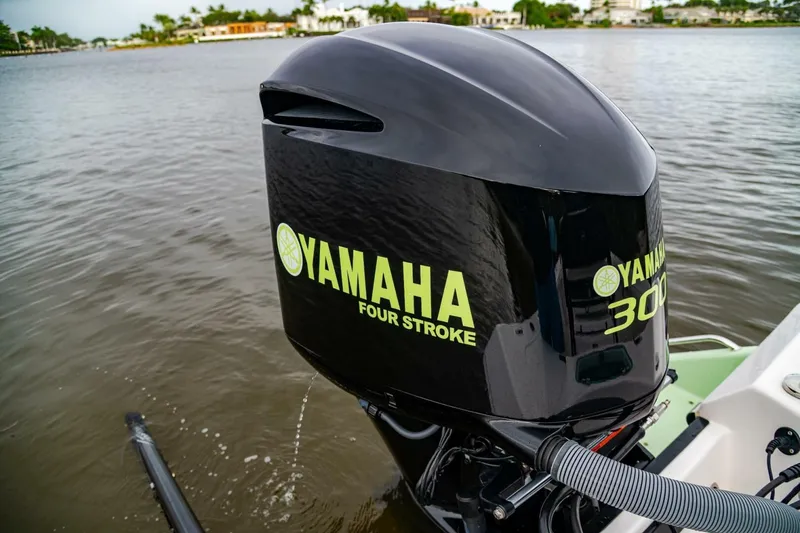 Slide: The Image of Yamaha 300 outboard engine on 2018 Everglades 243 Center Console boat, near water. - 32