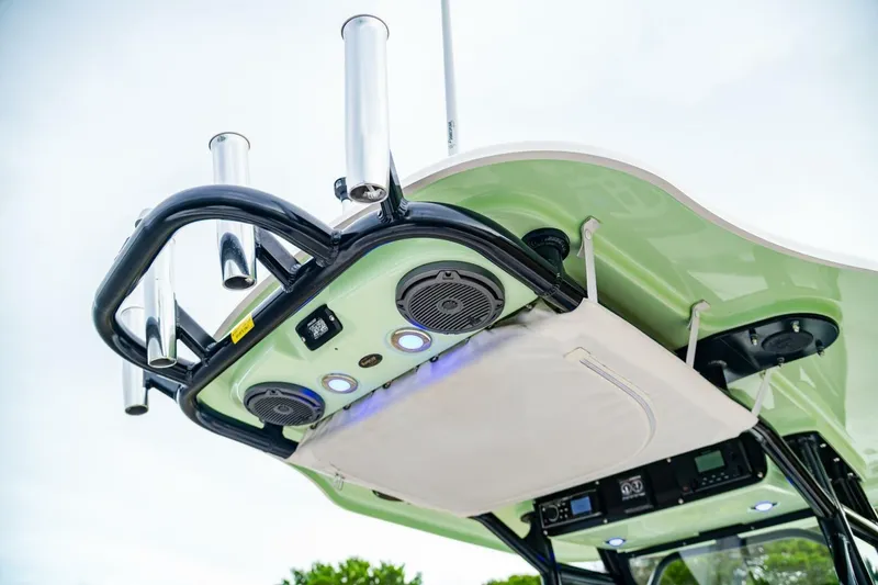 Slide: The Image of 2018 Everglades 243 Center Console boat with rod holders and speakers on the canopy. - 33